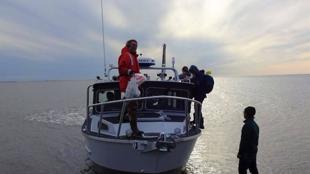 Sampling the lagoons by boat on open water